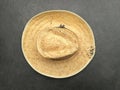 Closeup shot of an old straw hat made of raffia on gray background