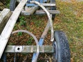 Closeup shot on an old trailer of a tractor and other junk in front of a barn