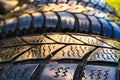 Closeup shot of old used worn car wheel tyres pile stacked in rows