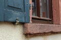 Closeup shot of an old windowsill with a wooden window cover Royalty Free Stock Photo