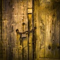 Closeup shot of an old wooden door locked with a padlock in Auvergne, France Royalty Free Stock Photo