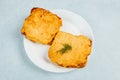 Closeup shot of omelet bread with dill on a plate on a turquoise surface