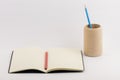 Closeup shot of an open blank book with a pencil cup isolated on white background Royalty Free Stock Photo