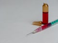 Closeup shot of an open glass ampule and syringe filled with a red liquid and copy space Royalty Free Stock Photo