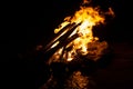 Closeup shot of an orange fire burning woods against a black background Royalty Free Stock Photo