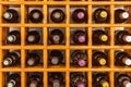Closeup shot of an orange rack with bottles of wine