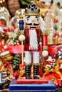 Closeup shot of ornamental wood doll of nutcracker on small stand in lights