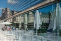 Closeup shot of an outdoor cafe and the glass wall of the Oslo Opera building