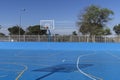 Closeup shot of an outdoors basketball field painted in blue