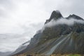 Closeup shot of over Eystrahorn mountain chaiin with fog ring around. Royalty Free Stock Photo