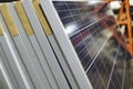 Closeup shot of packed solar panels on each other under the lights - environmental concept Royalty Free Stock Photo