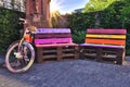 Closeup shot of painted pallet benches and a decorative bicycle; garden design ideas Royalty Free Stock Photo