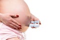 Closeup shot of a pair of baby shoes on the stomach of a pregnant woman Royalty Free Stock Photo