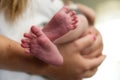 Closeup shot of a pair of small adorable baby feet