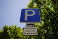 Closeup shot of a parking sign on a blue background with text on Portuguese in Lisbon, Portugal