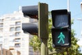 Closeup shot of a pedestrian traffic lights showing red and green with trees on the background