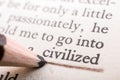 Closeup shot of a pencil underlining text word civilized in a book