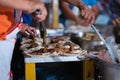Closeup shot of people preparing iconic Honduran street food baleada outdoors