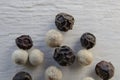 Closeup shot of peppercorns - white pepper and black pepper