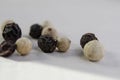 Closeup shot of peppercorns - white pepper and black pepper Royalty Free Stock Photo