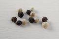 Closeup shot of peppercorns - white pepper and black pepper Royalty Free Stock Photo