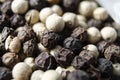 Closeup shot of peppercorns - white pepper and black pepper