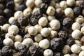 Closeup shot of peppercorns - white pepper and black pepper Royalty Free Stock Photo