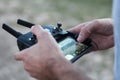 Closeup shot of a person controlling a drone with a remote on a blurred background Royalty Free Stock Photo