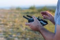 Closeup shot of a person controlling a drone with a remote on a blurred background Royalty Free Stock Photo