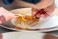 Closeup shot of a person eating grilled fish with gold leaf Royalty Free Stock Photo