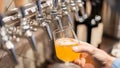 Closeup shot of a person filling in the glass with beer Royalty Free Stock Photo