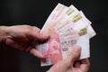 Closeup shot of a person holding Hong Kong dollars HKD