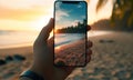 closeup shot of person holding mobile phone in hand and taking photo of sunset at sea, nature photography with Royalty Free Stock Photo