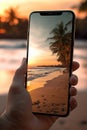 closeup shot of person holding mobile phone in hand and taking photo of sunset at sea, nature photography with Royalty Free Stock Photo