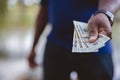 Closeup shot of a person holding three twenty dollar bills with a blurred background Royalty Free Stock Photo