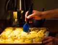 Closeup shot of a person oiling the raw batter Royalty Free Stock Photo