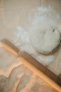 Closeup shot of a person preparing dough for pizza with a rolling pin Royalty Free Stock Photo