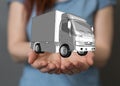 Closeup shot of a person presenting the virtual projection of a silver truck