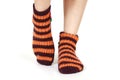 Closeup shot of a person's feet wearing striped orange socks