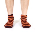 Closeup shot of a person's feet wearing striped orange socks Royalty Free Stock Photo