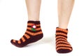 Closeup shot of a person's feet wearing striped orange socks Royalty Free Stock Photo