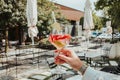 Closeup shot of a person's hand holding a glass of cocktail Royalty Free Stock Photo