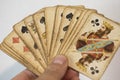 Closeup shot of a person's hand holding old weathered playing cards Royalty Free Stock Photo