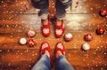 Closeup shot of a persons feet wearing red and white socks on a Christmas background, Ai-generated. Royalty Free Stock Photo