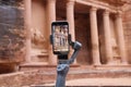 Closeup shot of a phone documenting an ancient architectural building