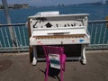 Closeup shot of a piano in public near the sea