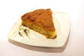 Closeup shot of a piece of homemade baked pie on white plate isolated on a white background