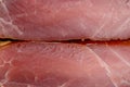 Closeup shot of a piece of smoked bacon on a wooden surface