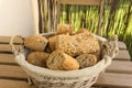 Closeup shot of pieces of fresh bread in a basket on a wooden surface Royalty Free Stock Photo