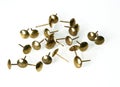 Closeup shot of a pile of antique bronze pin nails isolated on a white background